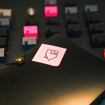 miniature houses model of the estate folder with housing loan documents pink sticky mote home picture